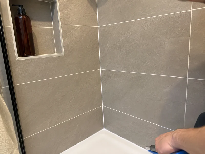 Regrouted and resealed bathroom shower corner